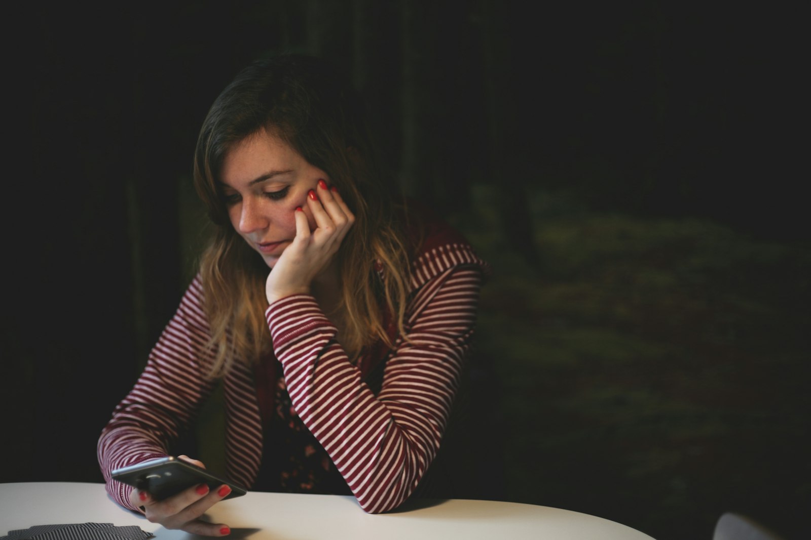 Celebrity romance scam: a woman messaging a fake celebrity profile on her phone